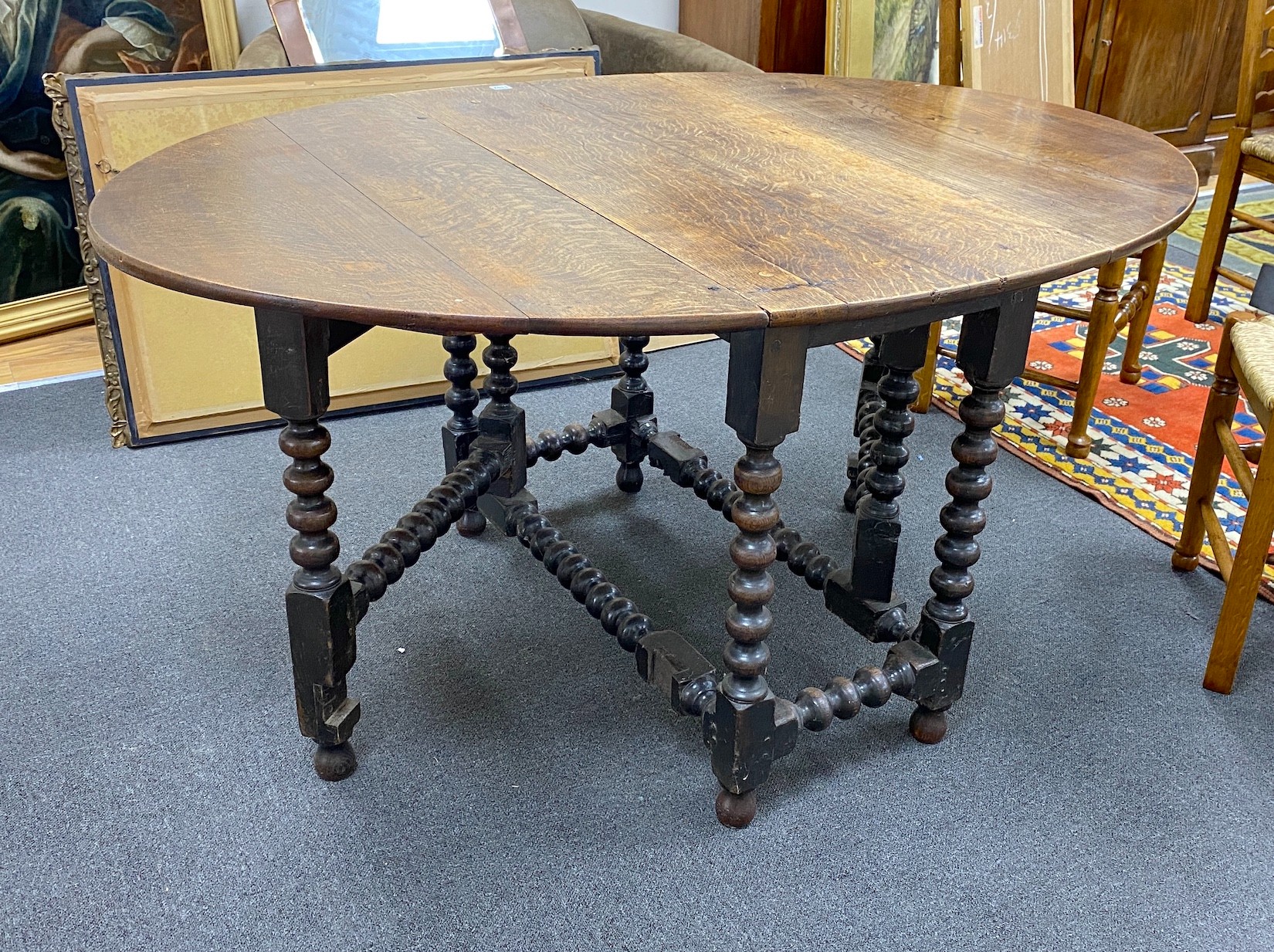 An early 19th century oak bobbin leg gateleg dining table, length 154cm extended, width 108cm, height 76cm